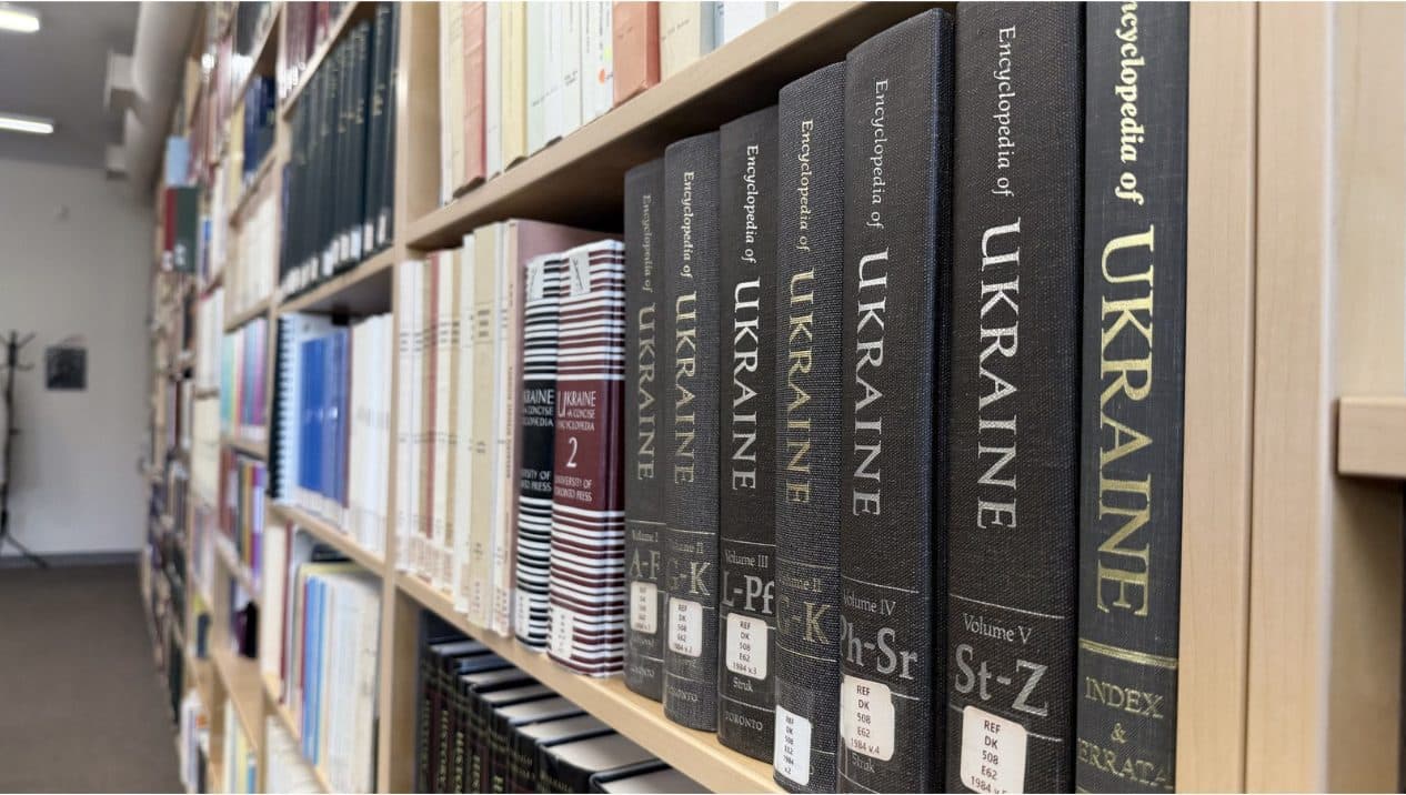 Ukrainian reference books line the shelves of a church resource library