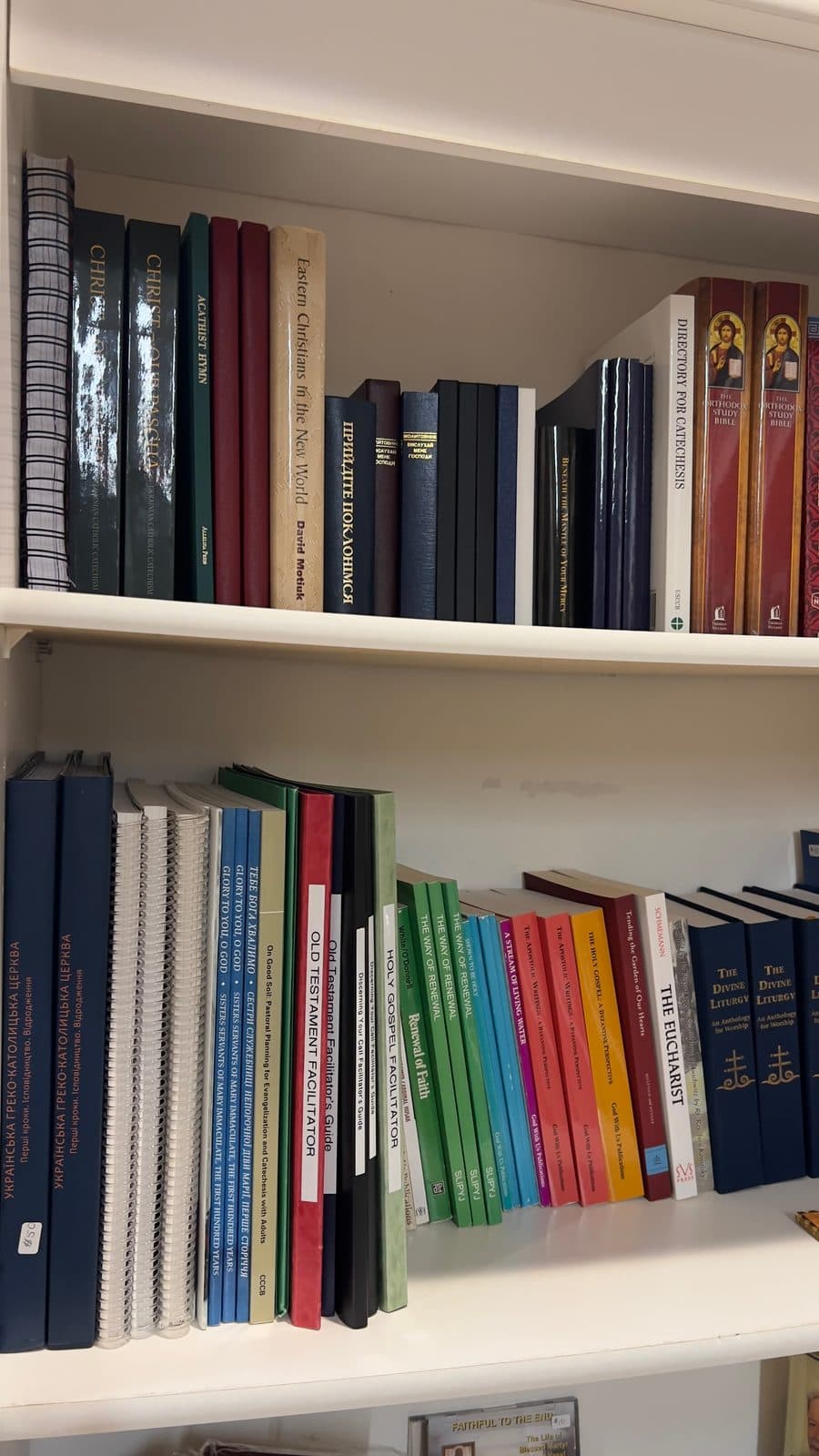 Religious children’s books and icon-themed activity materials arranged on a wooden display table